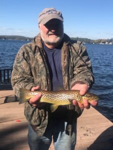 Alan Tuorinski holding an 18" brown trout caught from his dock in Mt. Arlington on October 9, 2022. The fish was quickly released back into Lake Hopatcong.